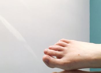 Close-up of hand on wall