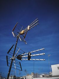 Low angle view of crane against blue sky