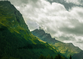 Scenic view of mountains against cloudy sky