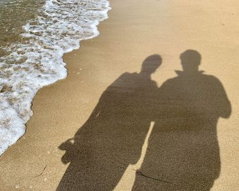 Male and female shadow on the beach