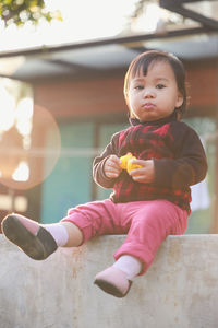 Little cute kid child innocence hold small yellow toy play joy fun with beautiful flare 