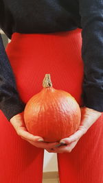 Close-up of hand holding pumpkin