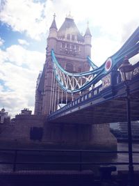 Low angle view of bridge against cloudy sky