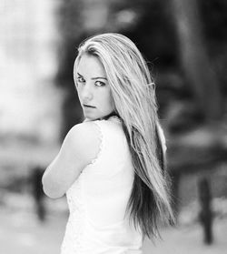 Portrait of young woman standing outdoors