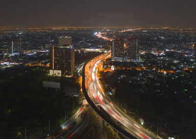 High angle view of illuminated buildings against sky at night