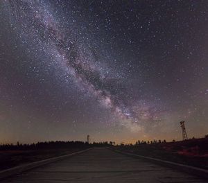 Scenic view of road against sky at night