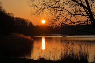 Scenic view of lake against sky during sunset