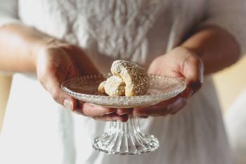 Mid section view of chief holding dessert in glass