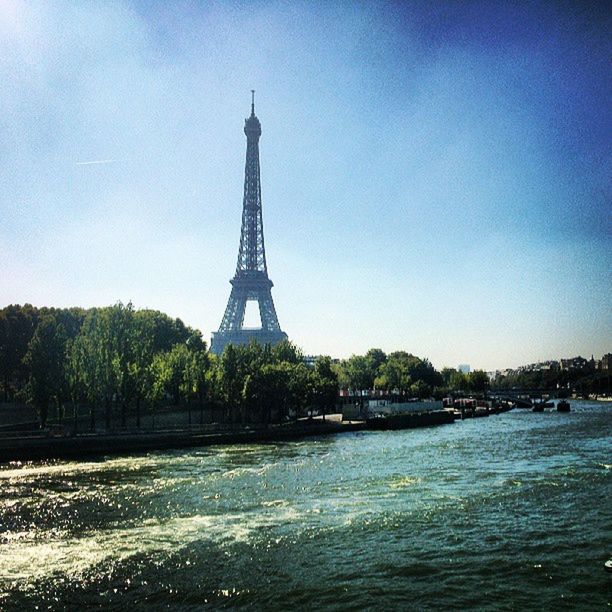 eiffel tower, built structure, architecture, international landmark, famous place, tower, travel destinations, culture, tall - high, tourism, water, travel, tree, capital cities, clear sky, metal, sky, building exterior, history, low angle view