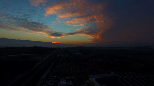 Aerial view of city against cloudy sky