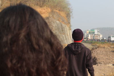 Rear view of man by woman with long hair