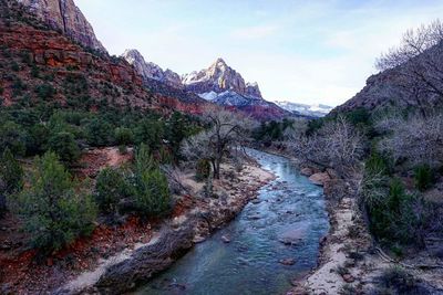 Scenic view of river amidst mountains against sky