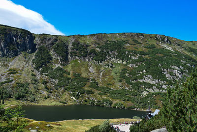 Scenic view of mountains against blue sky