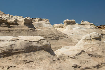 Low angle view of rock formations against sky