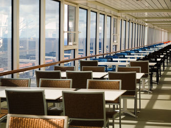 Empty chairs and tables in building