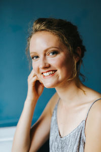 Portrait of smiling young woman at cafe