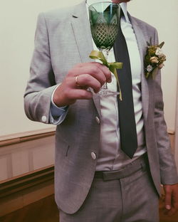 Midsection of couple holding hands