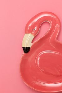 High angle view of red toy over pink background