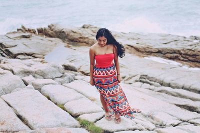 Portrait of young woman standing on beach