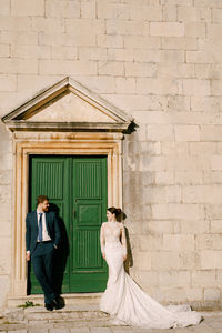 Couple standing in front of building