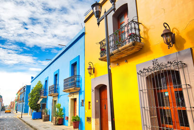 Low angle view of yellow buildings against sky