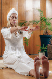 Woman practicing kundalini yoga, kriya exercises for the navel center and bowel waste elimination