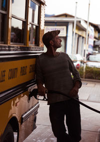 Man standing on road in city