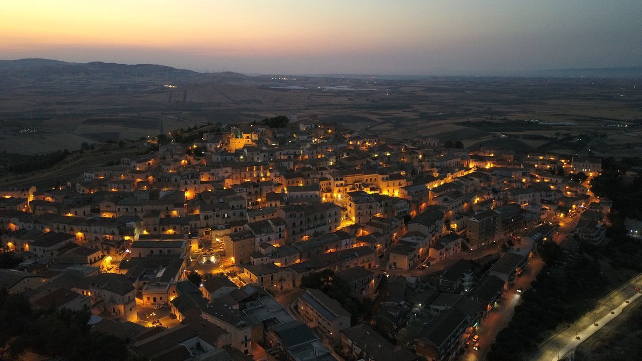 HIGH ANGLE VIEW OF ILLUMINATED CITY