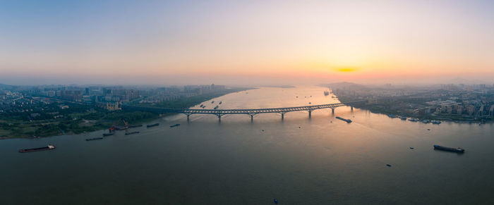 High angle view of bridge over river against sky during sunset