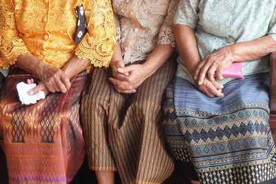 Midsection of women wearing traditional clothing