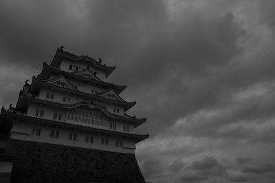 Low angle view of himeji castle against cloudy sky