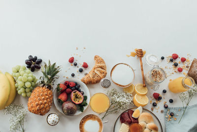 High angle view of breakfast on table against white background