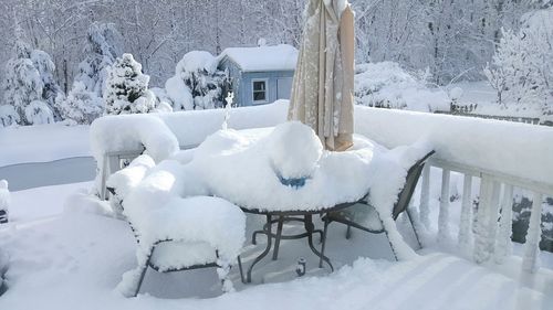 Snow covered landscape and chairs in winter