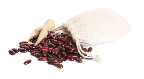 High angle view of roasted coffee beans against white background