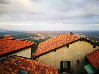 Houses in city against sky