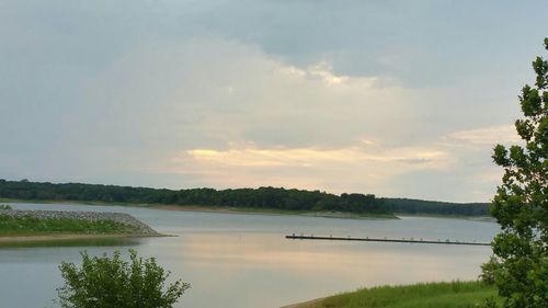 Scenic view of lake against cloudy sky