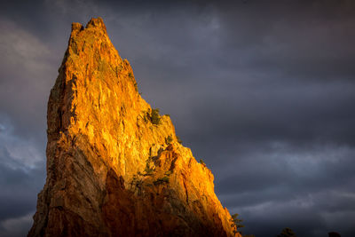 Low angle view of rock formation against sky