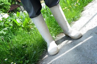 Low section of woman standing on road