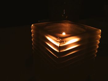 Close-up of illuminated lamp against black background