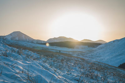 Scenic view of snowcapped mountains against clear sky