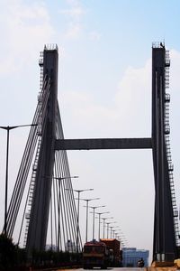 View of suspension bridge against cloudy sky