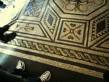 Low section of person standing on tiled floor