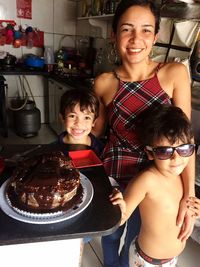 Portrait of smiling boys with mother