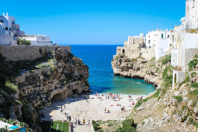 High angle view of sea and buildings against clear sky