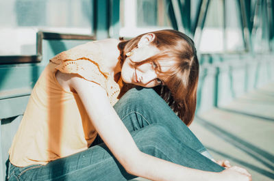 Beautiful woman sitting outdoors in sunny day