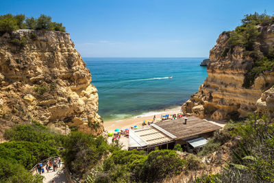 High angle view of rocks and sea against sky