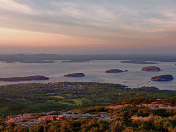 Scenic view of landscape against dramatic sky during sunset