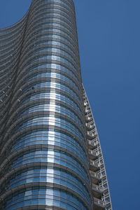 Low angle view of modern building against clear blue sky