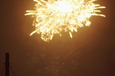 Low angle view of firework display at night