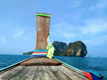Lifeguard hut on sea against blue sky